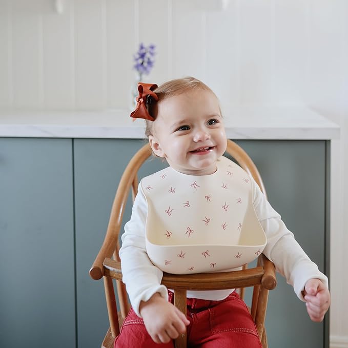 mushie Silicone Baby Bib | Adjustable Fit Waterproof Bibs (Bows)-BubblyBeeBaby