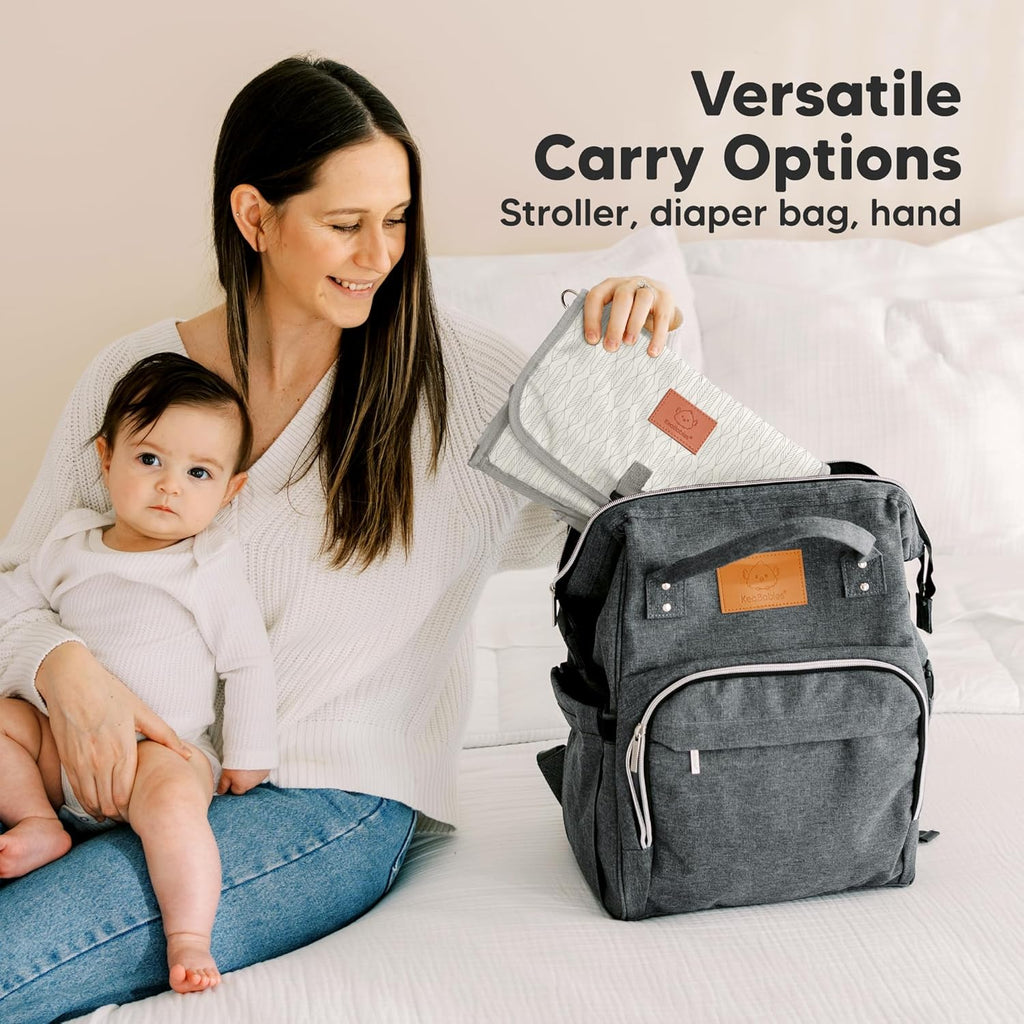 KeaBabies Portable Diaper Changing Pad - Large Waterproof Baby Changing Mat, Compact Travel Diaper Clutch, Functional Pockets Fit Newborn Essentials, Wipeable & Padded Baby Changer (Prism)